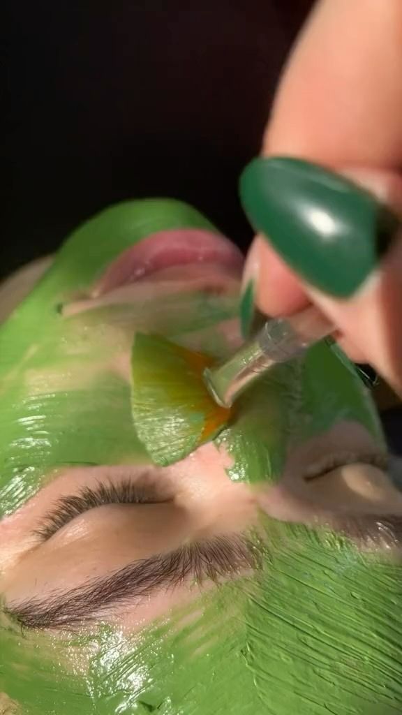 A Person Peeling Off a Green Face Mask, With a Green-painted Nail — Sage Spa & Beauty in Mackay, QLD