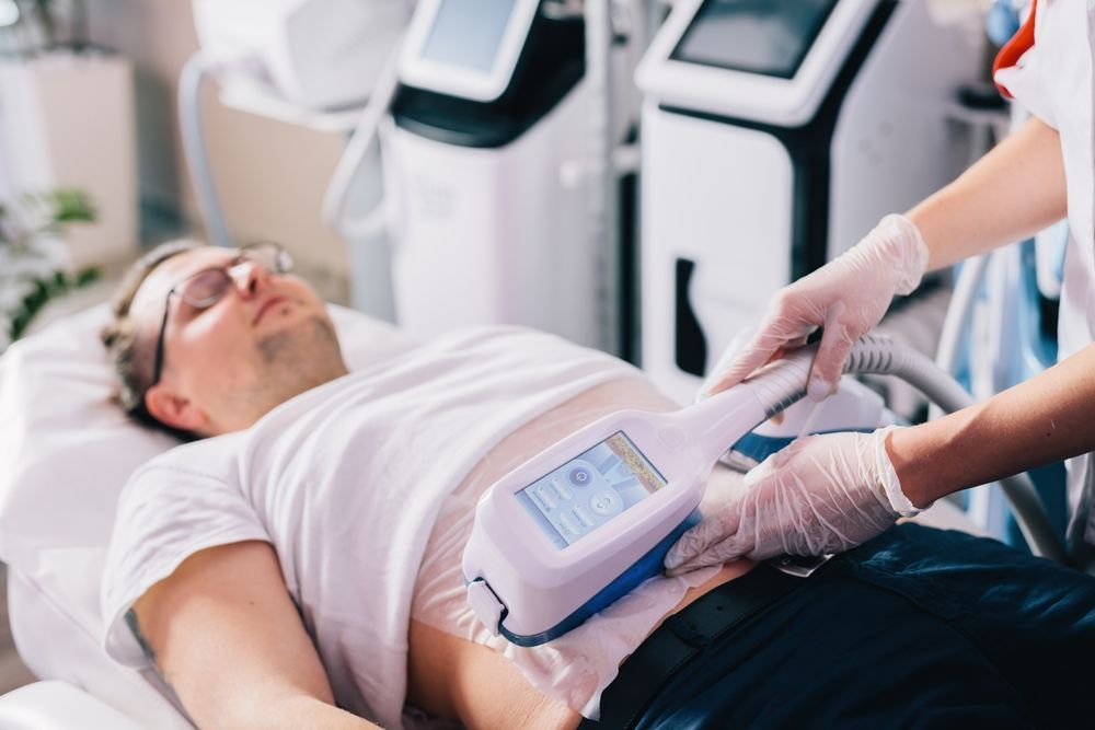 Man Receiving Body Contouring Treatment on Stomach — Sage Spa & Beauty in Mackay, QLD