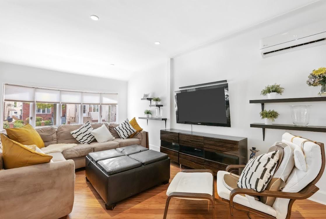 A living room filled with furniture and a flat screen tv.
