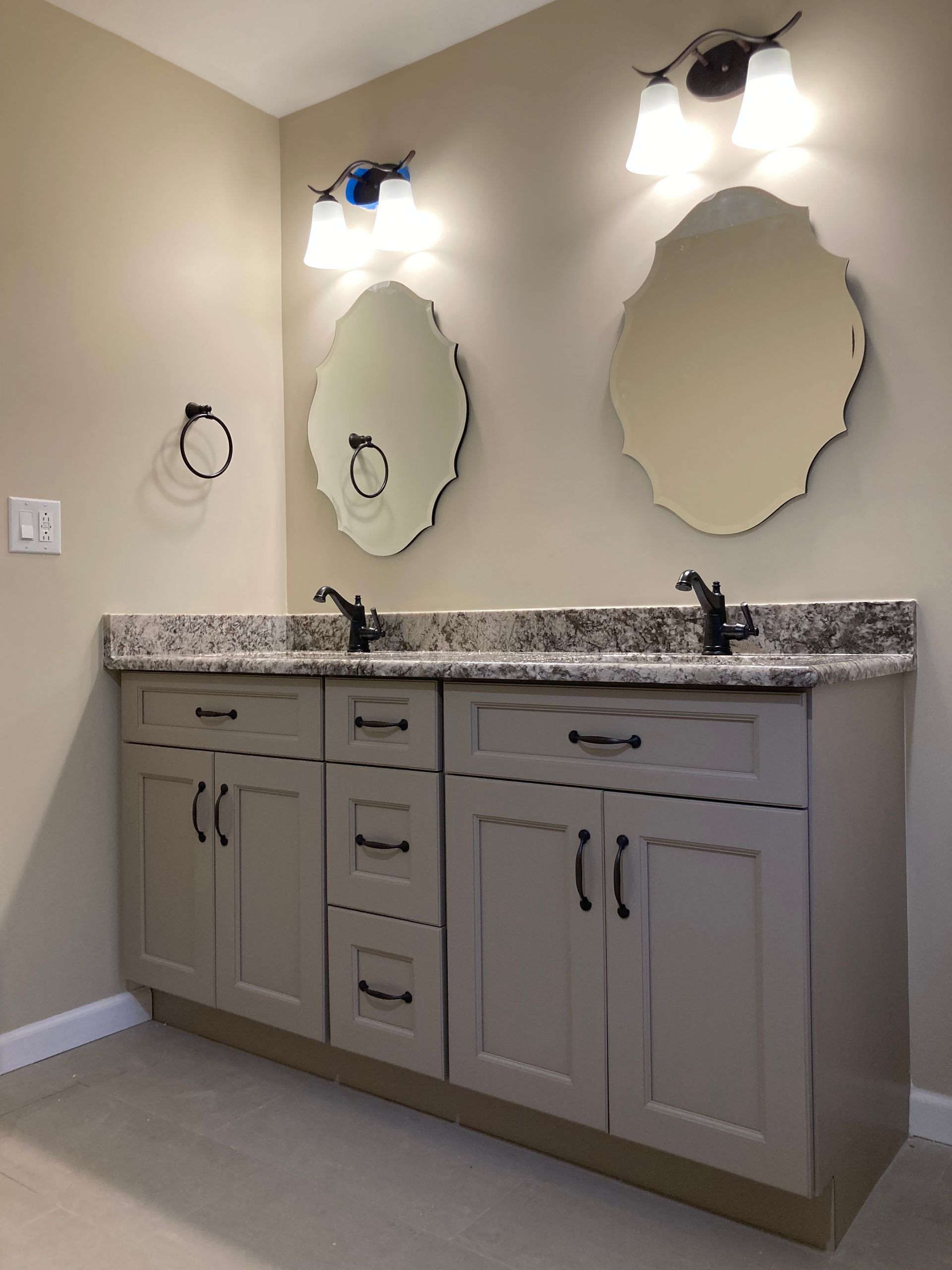 A bathroom with two sinks and two mirrors