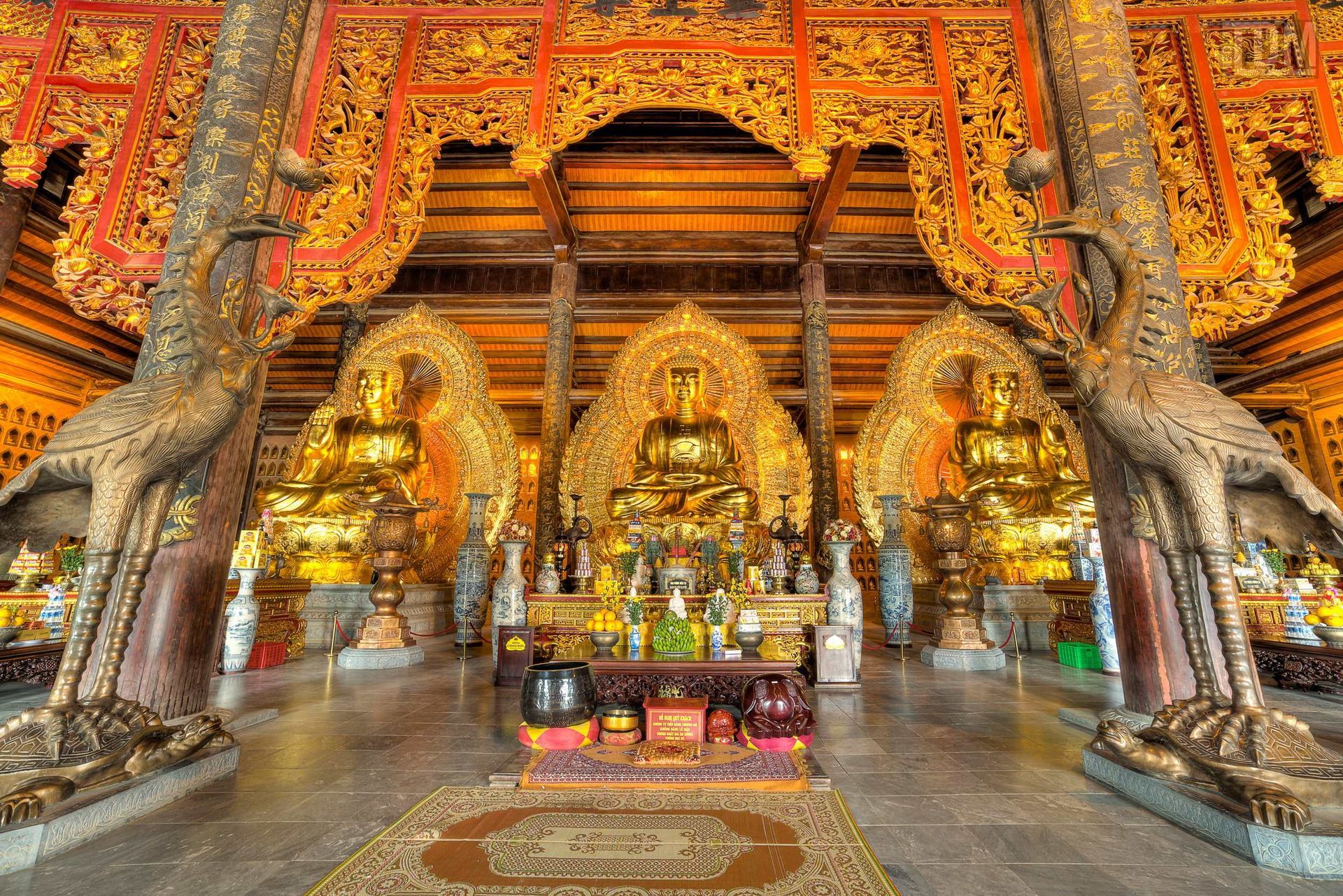 A magnificent golden Buddhist temple with intricate decorations and statues, representing spiritual and cultural heritage in Vietnam.