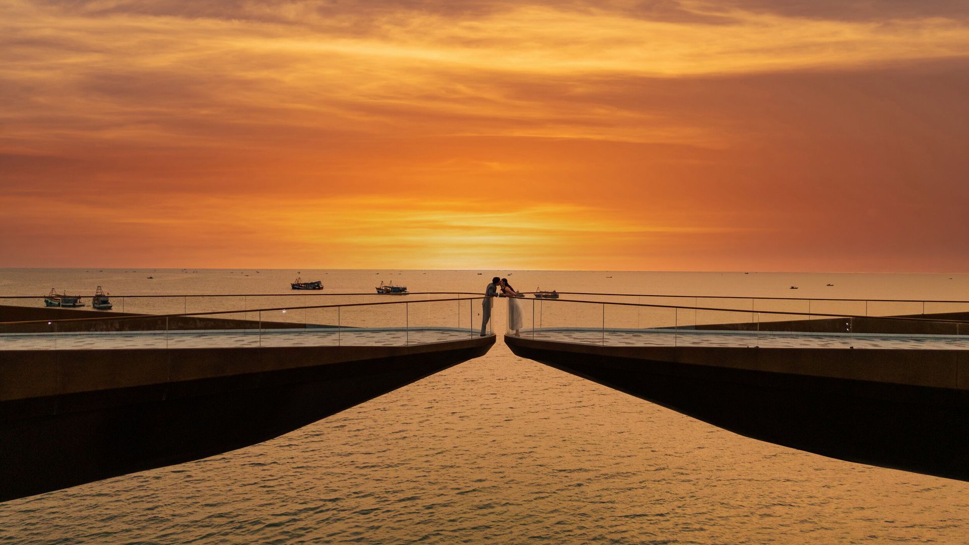 A couple embraces at Kiss Bridge, a dreamy sunset spot in Phu Quoc, Vietnam’s top romantic getaway.