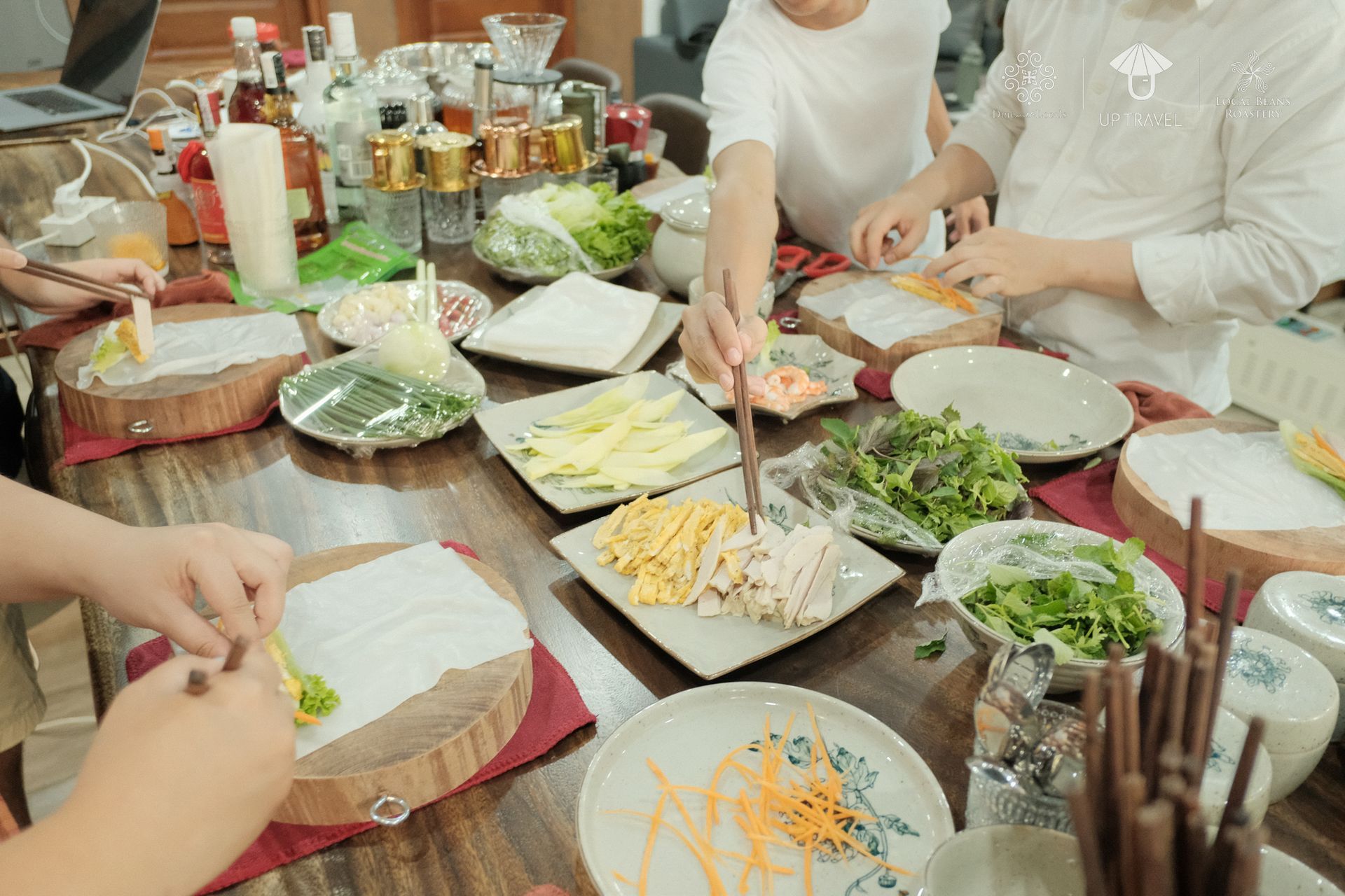 Preparing spring rolls with fresh ingredients in a Vietnamese cooking class.