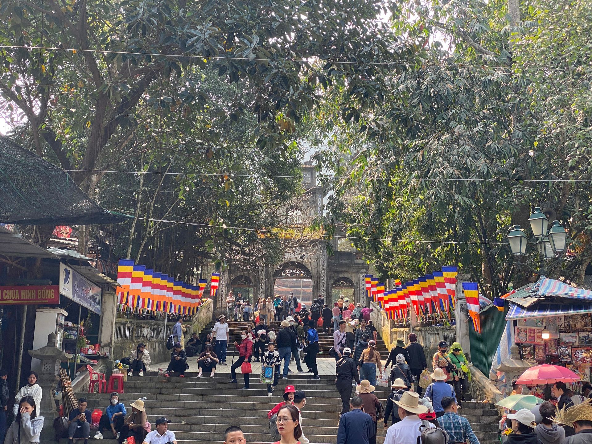 Crowds of people walking up the stone steps leading to the main entrance of the Perfume Pagoda (Chua Huong).