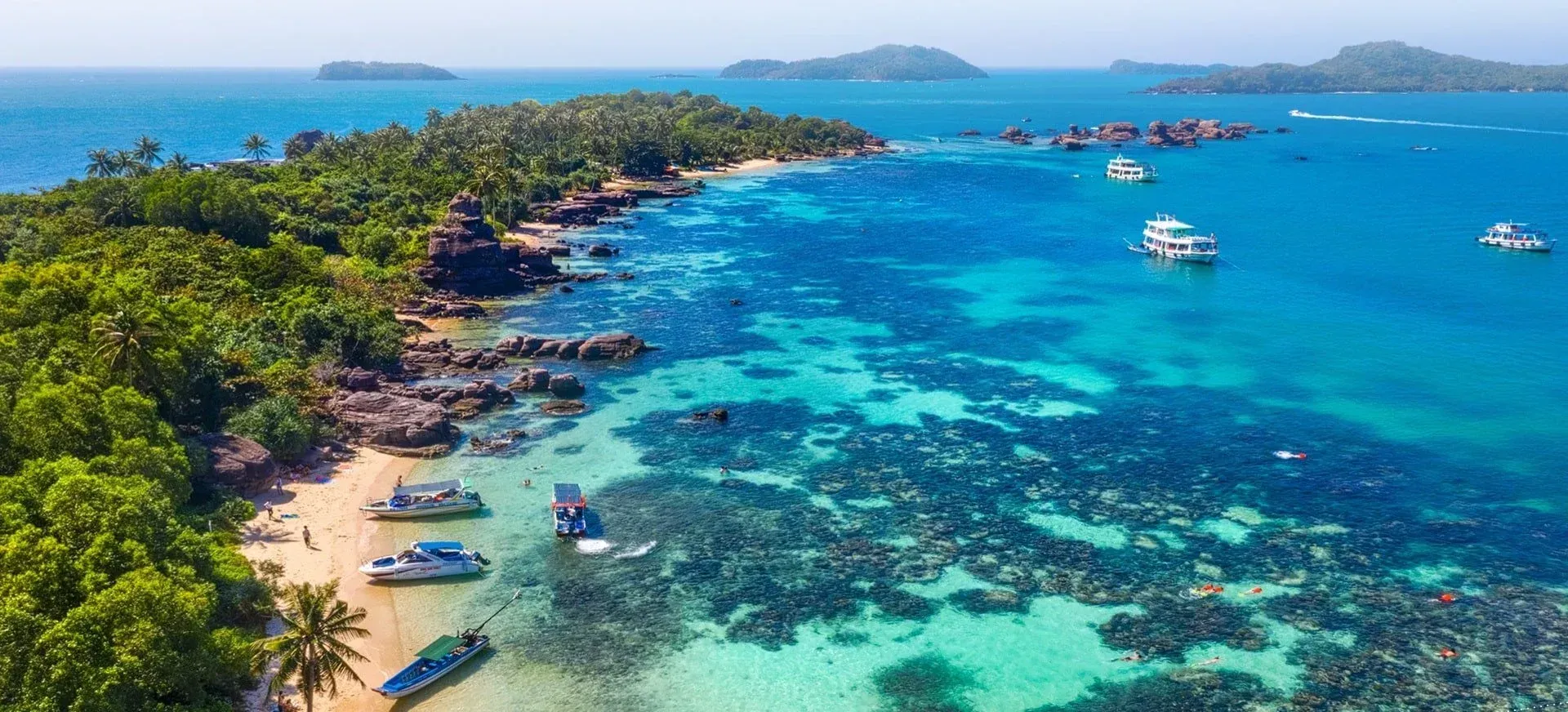 A breathtaking panorama of Phu Quoc Island showcasing lush greenery and pristine sandy beaches.