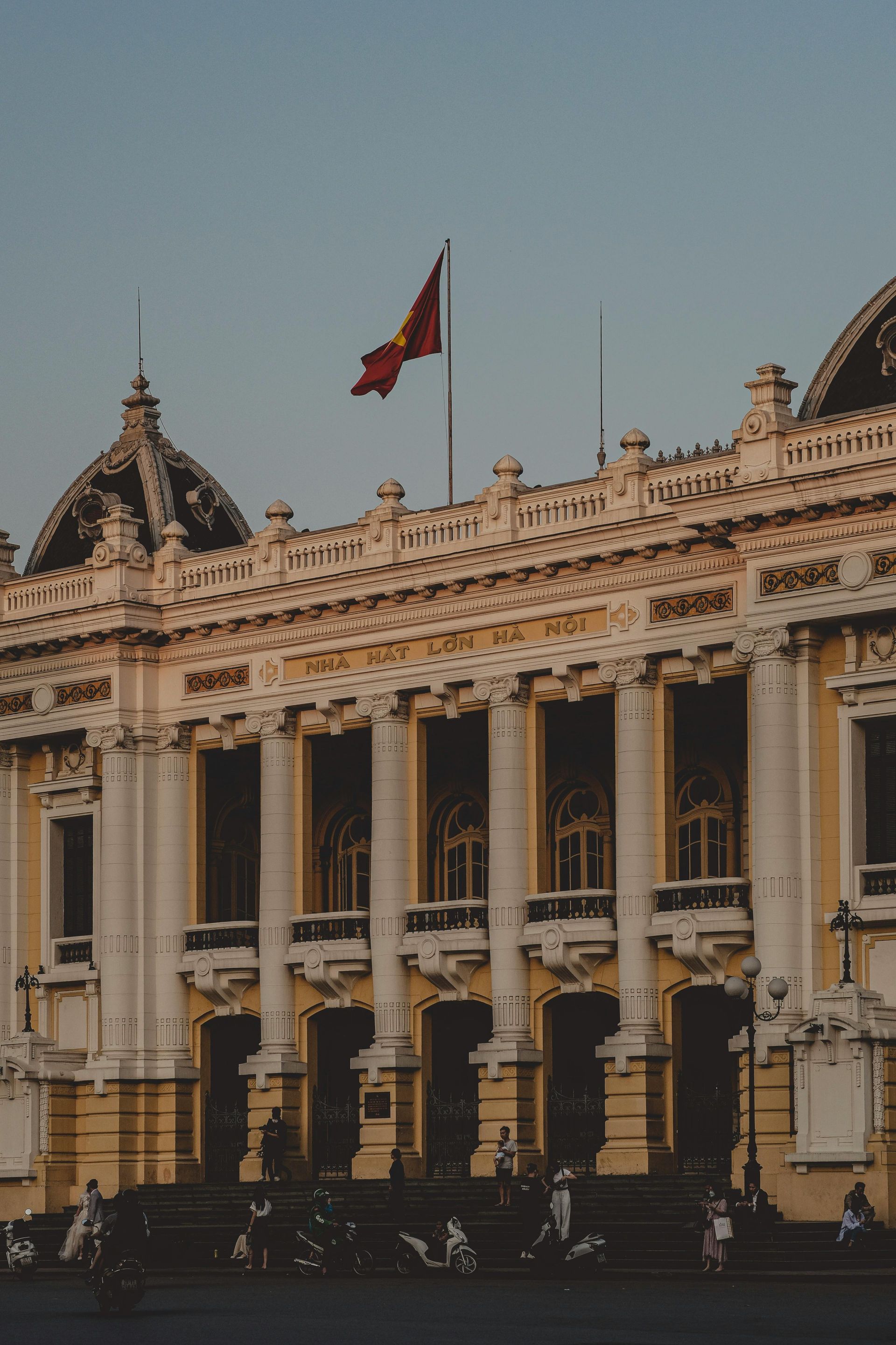 The ornate façade of the Hanoi Opera House, showcasing French colonial architecture with intricate columns and decorative details.