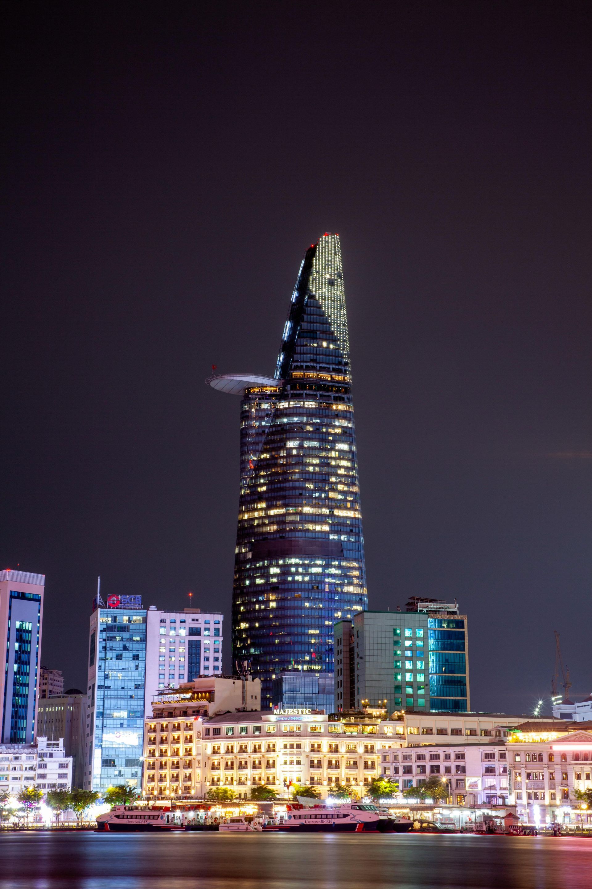 The Bitexco Financial Tower in Ho Chi Minh City, Vietnam, illuminated against the night sky, showcasing modern architecture.