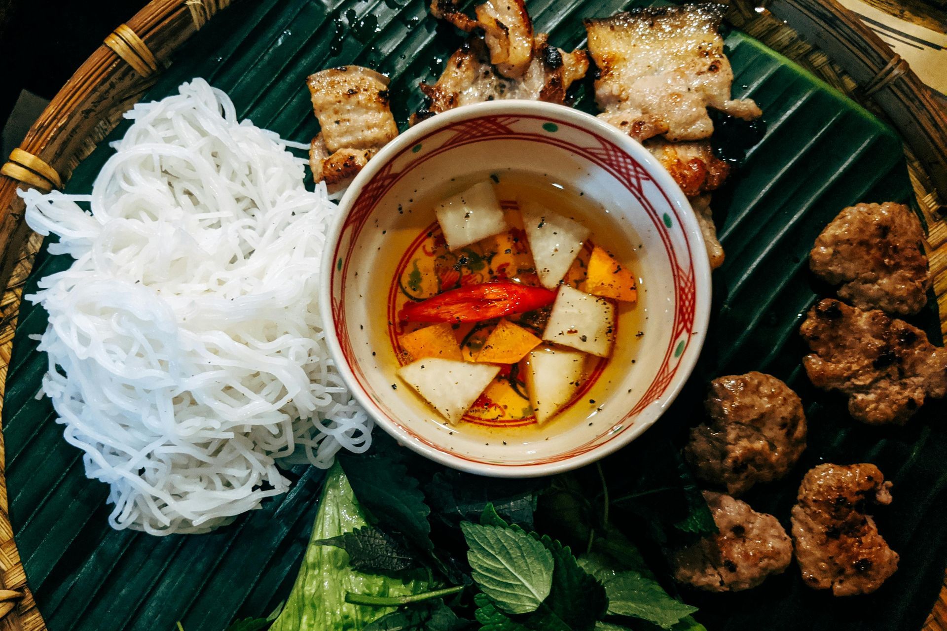 Hanoi’s famous bún chả with grilled pork, vermicelli, and dipping sauce.