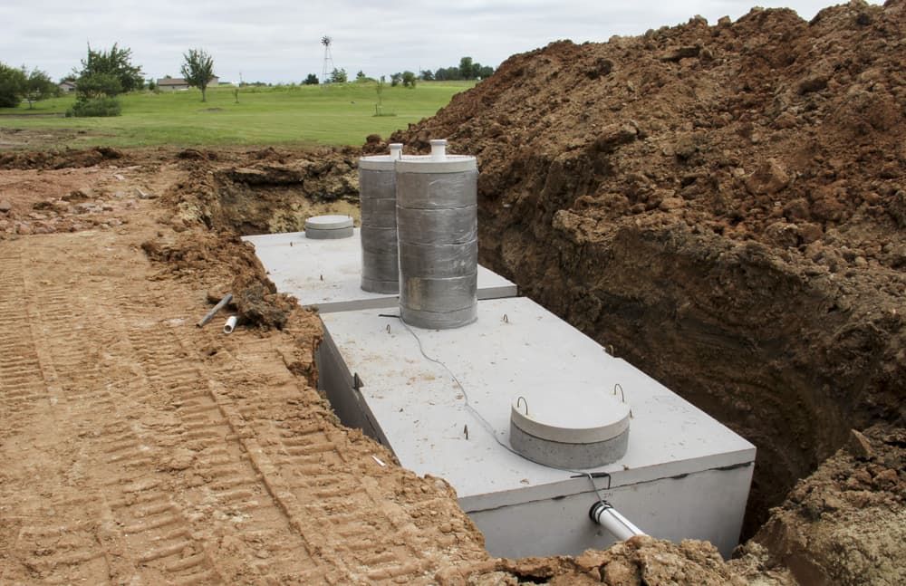 A Septic Tank Is Sitting in The Dirt Next to A Pile of Dirt — Custys Plumbing Services in Trinity Park, QLD
