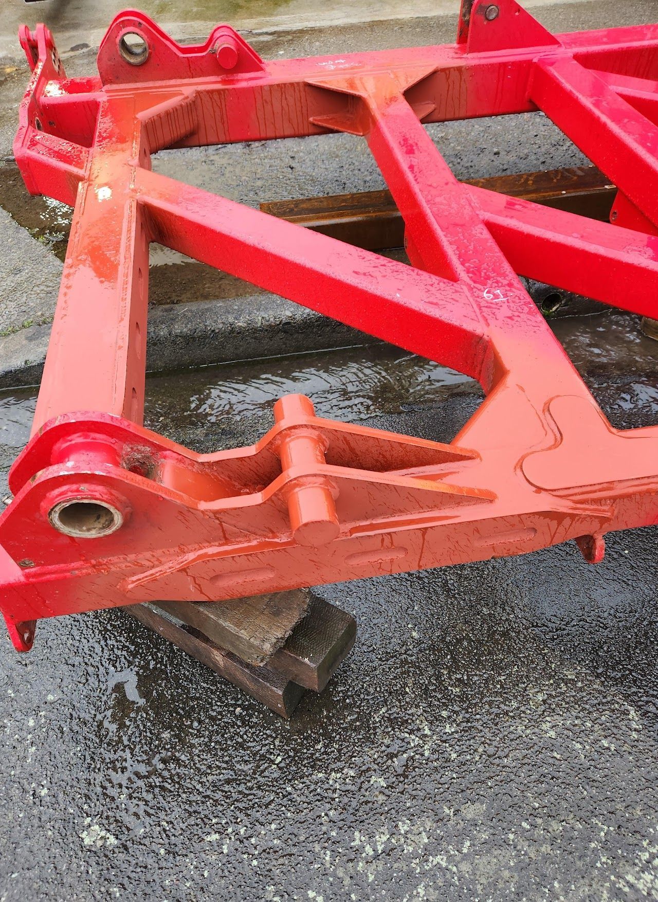 A red metal frame is sitting on the ground.