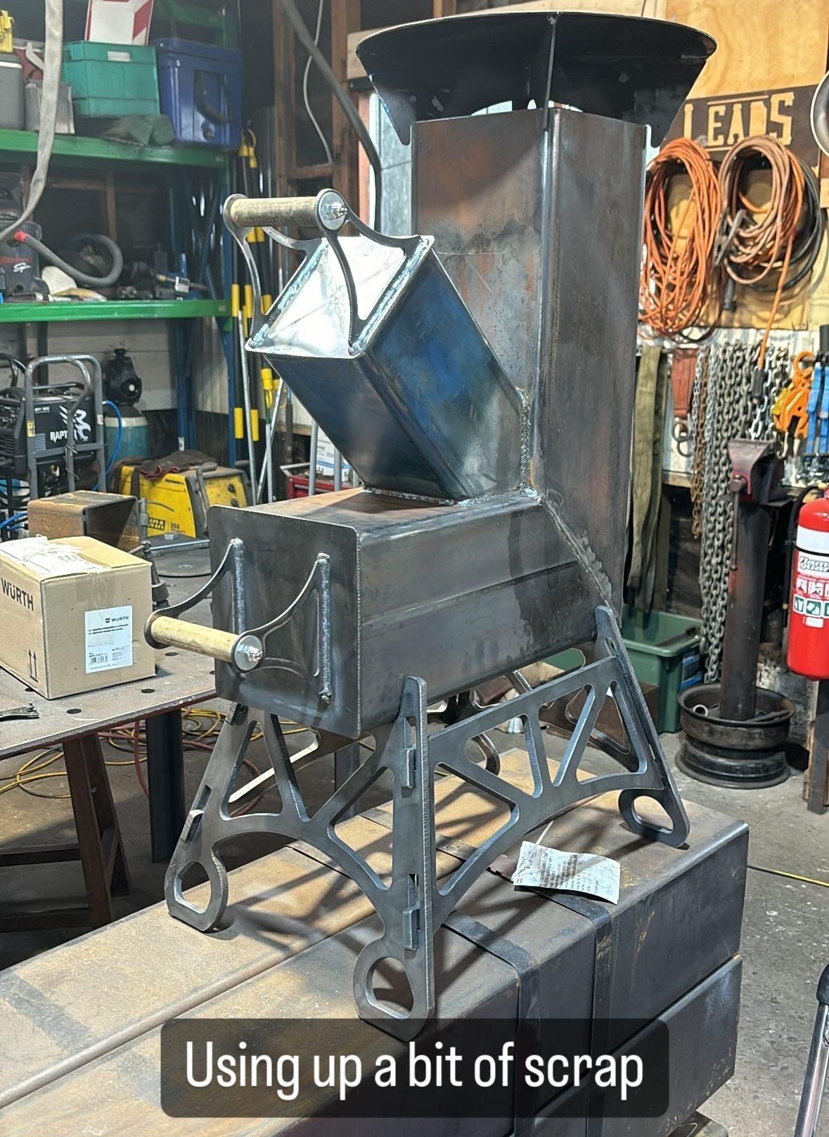 A picture of a rocket stove made out of scrap metal.