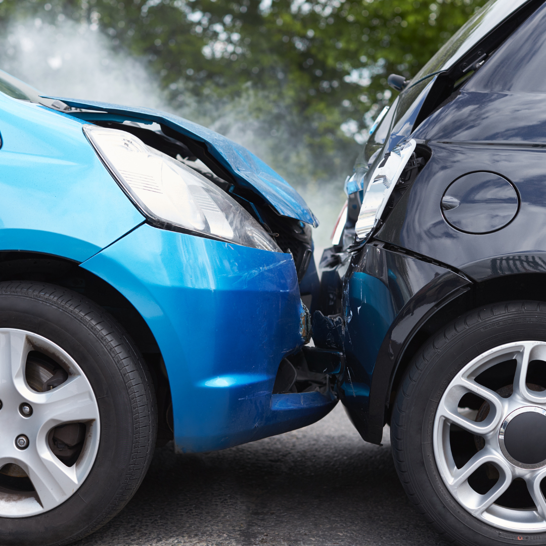 A blue car and a black car are crashed into each other