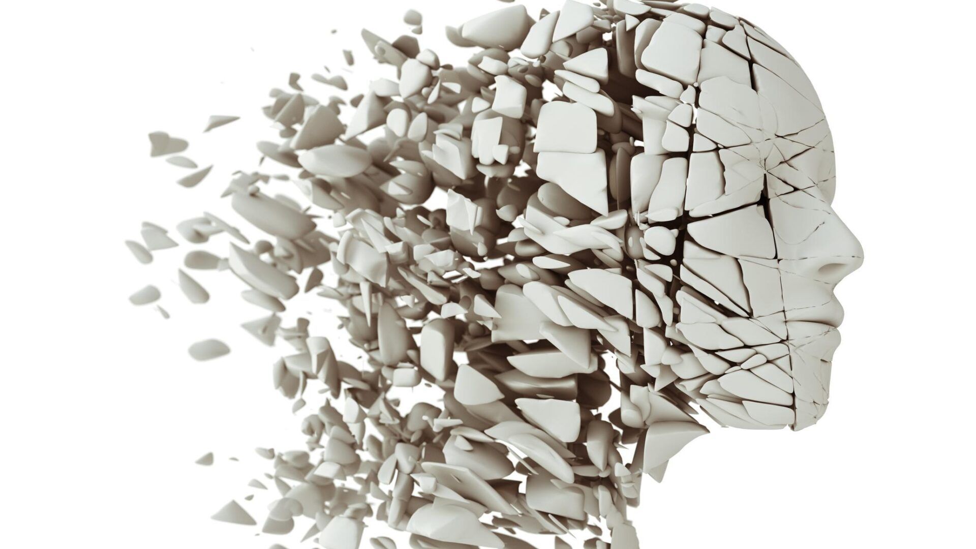 A white, human-shaped head sculpture fracturing and disintegrating into small, scattered pieces against a white background.