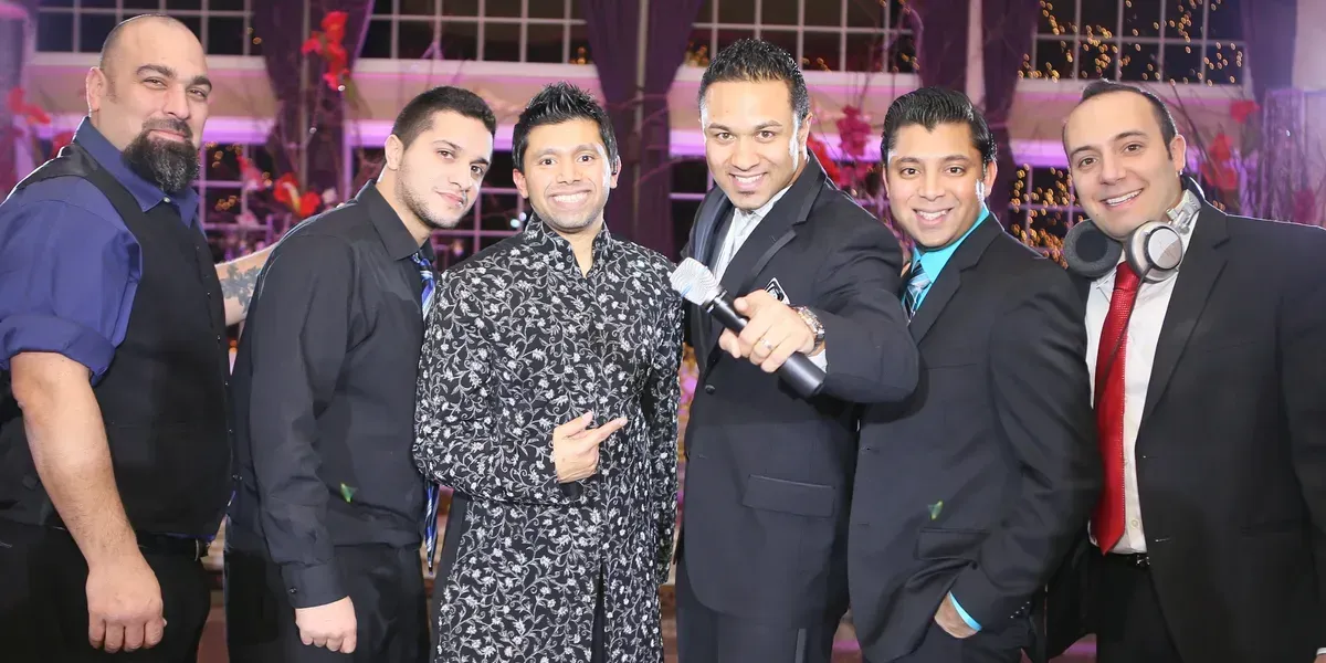 Musica Entertainemnt DJ and MC Crew, Six men posing for a photo at a wedding event. 
