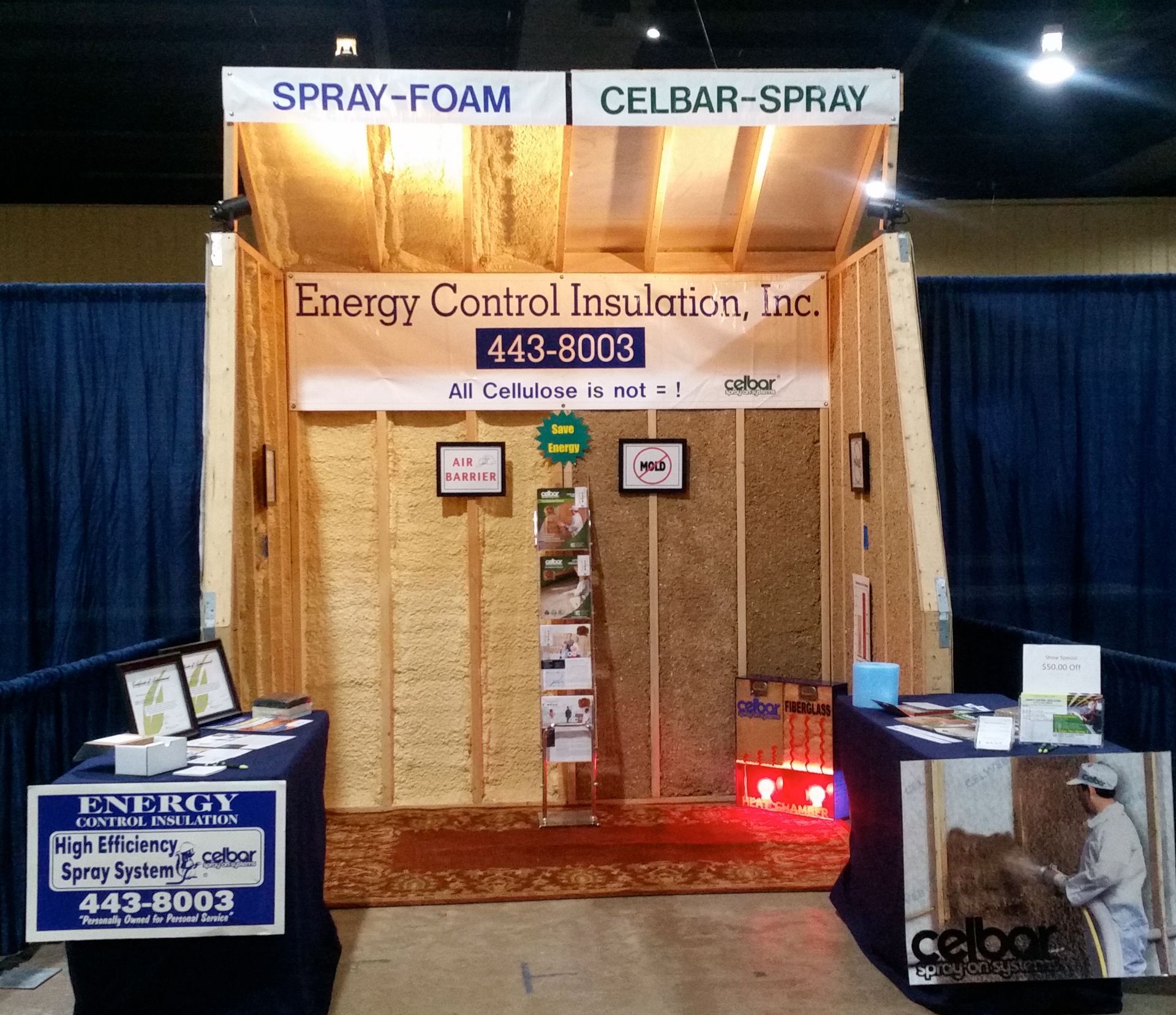 A trade show display for Energy Control Insulation, Inc. showing spray-foam and Celbar-spray insulation wall samples.