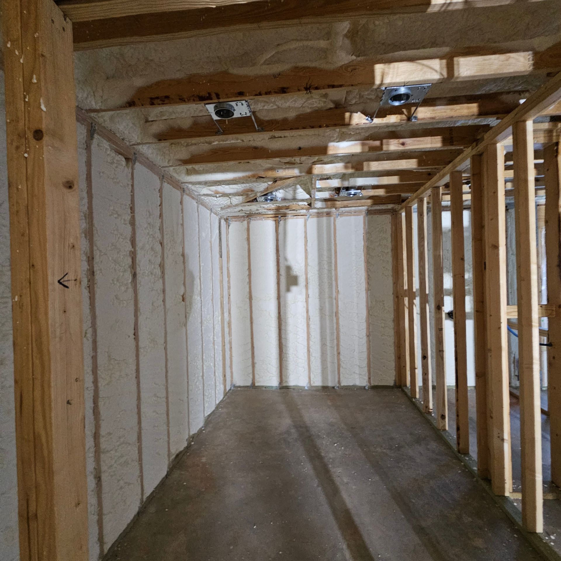 A room with a lot of wooden walls and a window