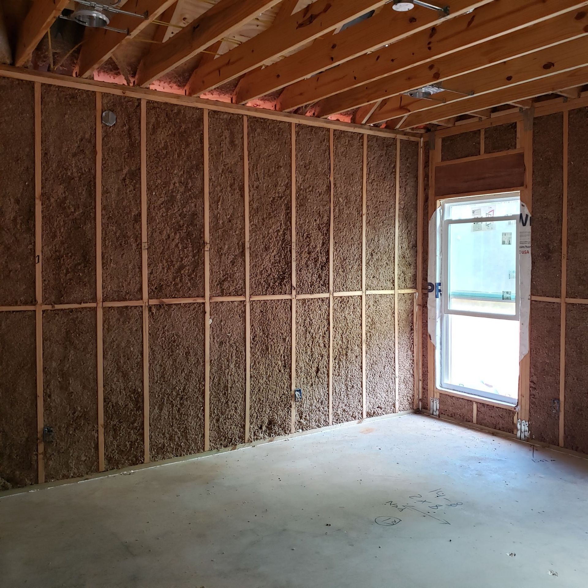 An empty room with a window and a box that says n on it