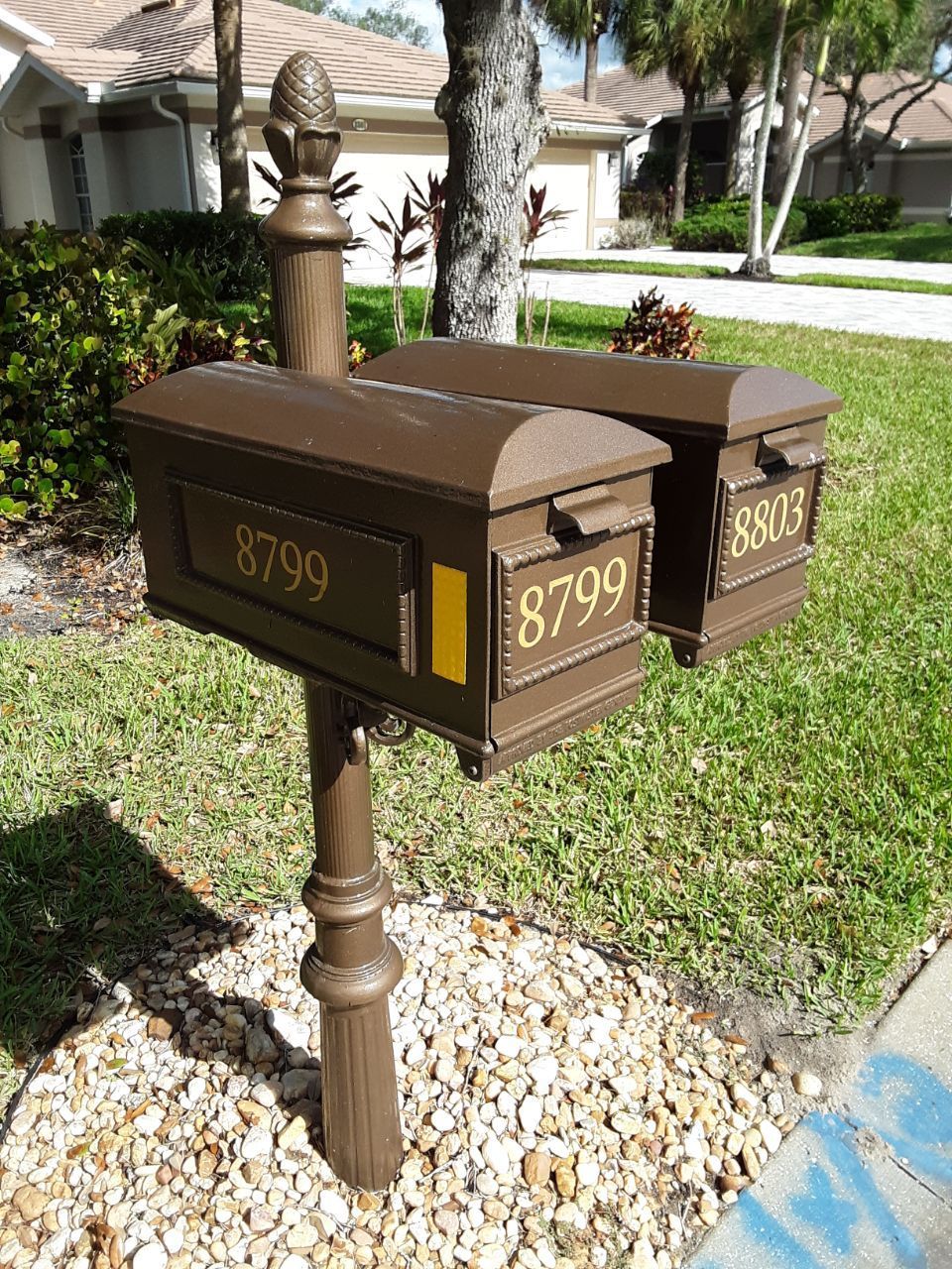 A couple of mailboxes sitting next to each other in a yard.