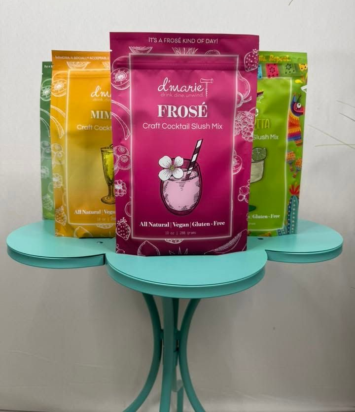 Assorted colorful frosted cookie packages displayed on teal tables