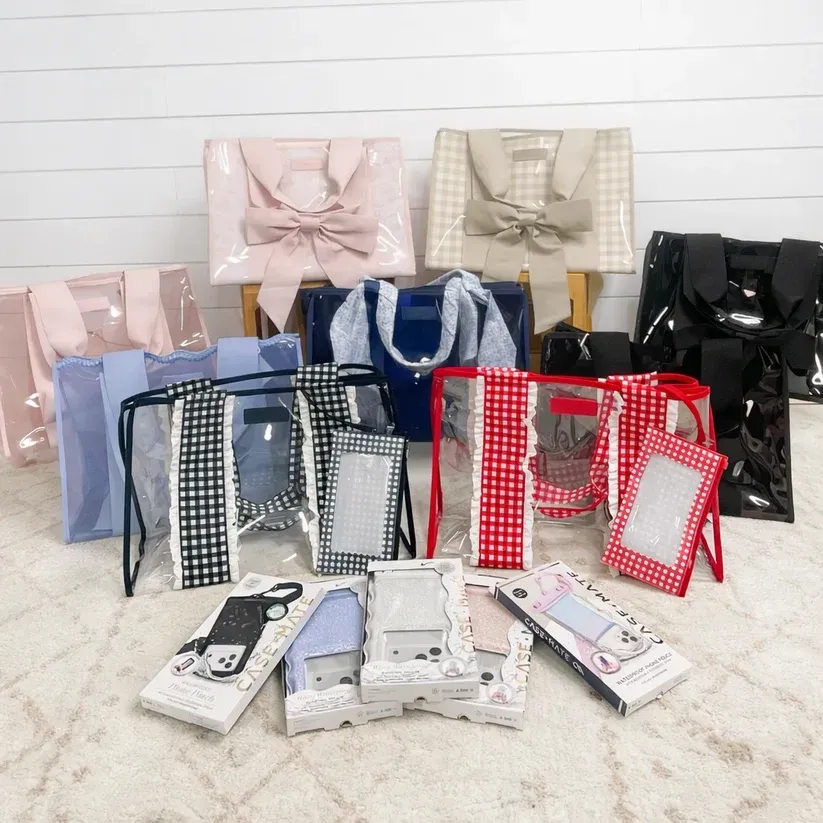 Assorted glossy gift bags and phone cases in pastel, blue, black, red, and white arranged on a tabletop.
