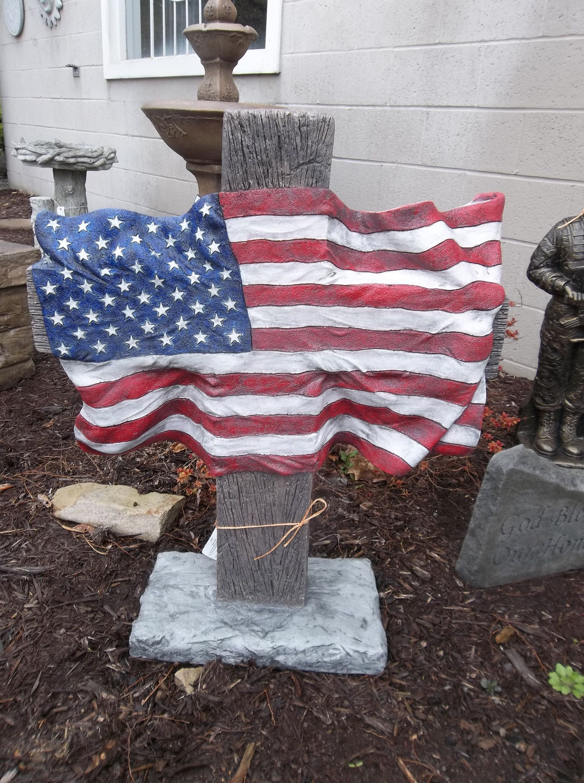 A statue with an american flag on top of it