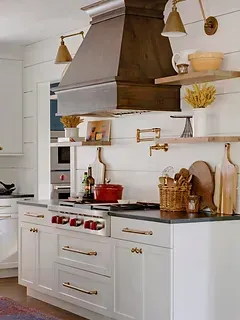 A kitchen with white cabinets and a stove top oven