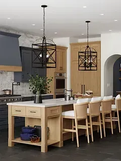 A kitchen with a large island , stools , and a stove.