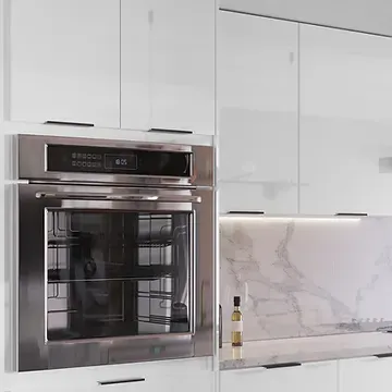A kitchen with white cabinets and a stainless steel oven.