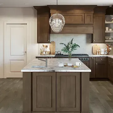 A kitchen with wooden cabinets and a large island in the middle.