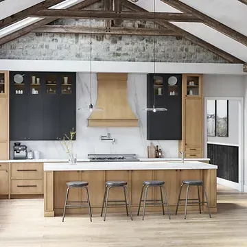 A kitchen with wooden cabinets , stools , a stove , and a large island.