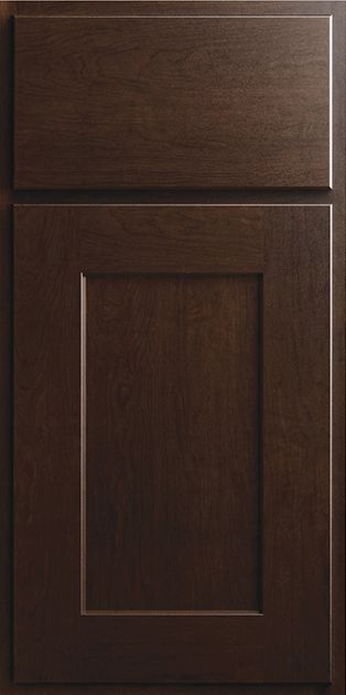 A close up of a dark wooden cabinet door.
