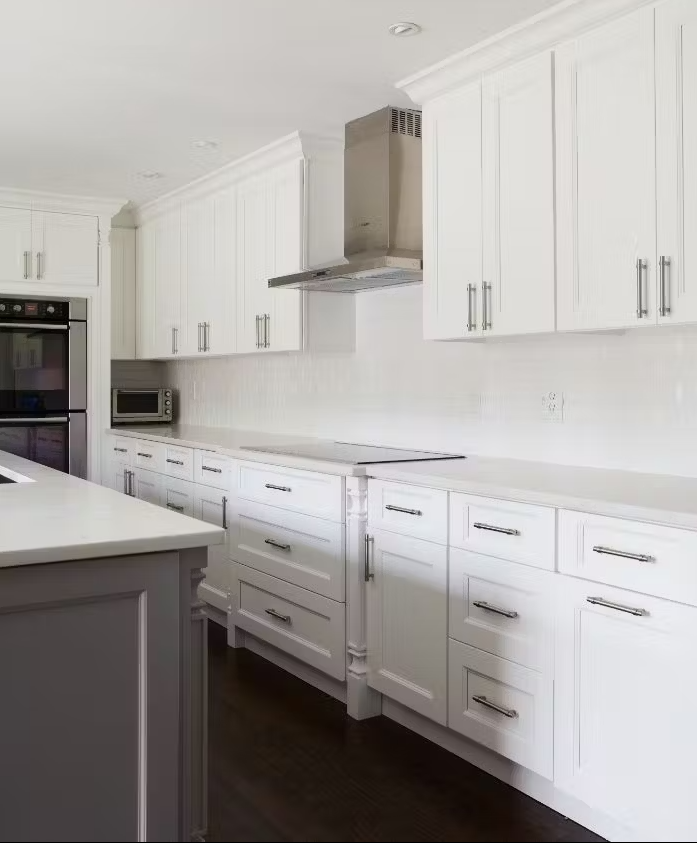 A kitchen with white cabinets and stainless steel appliances