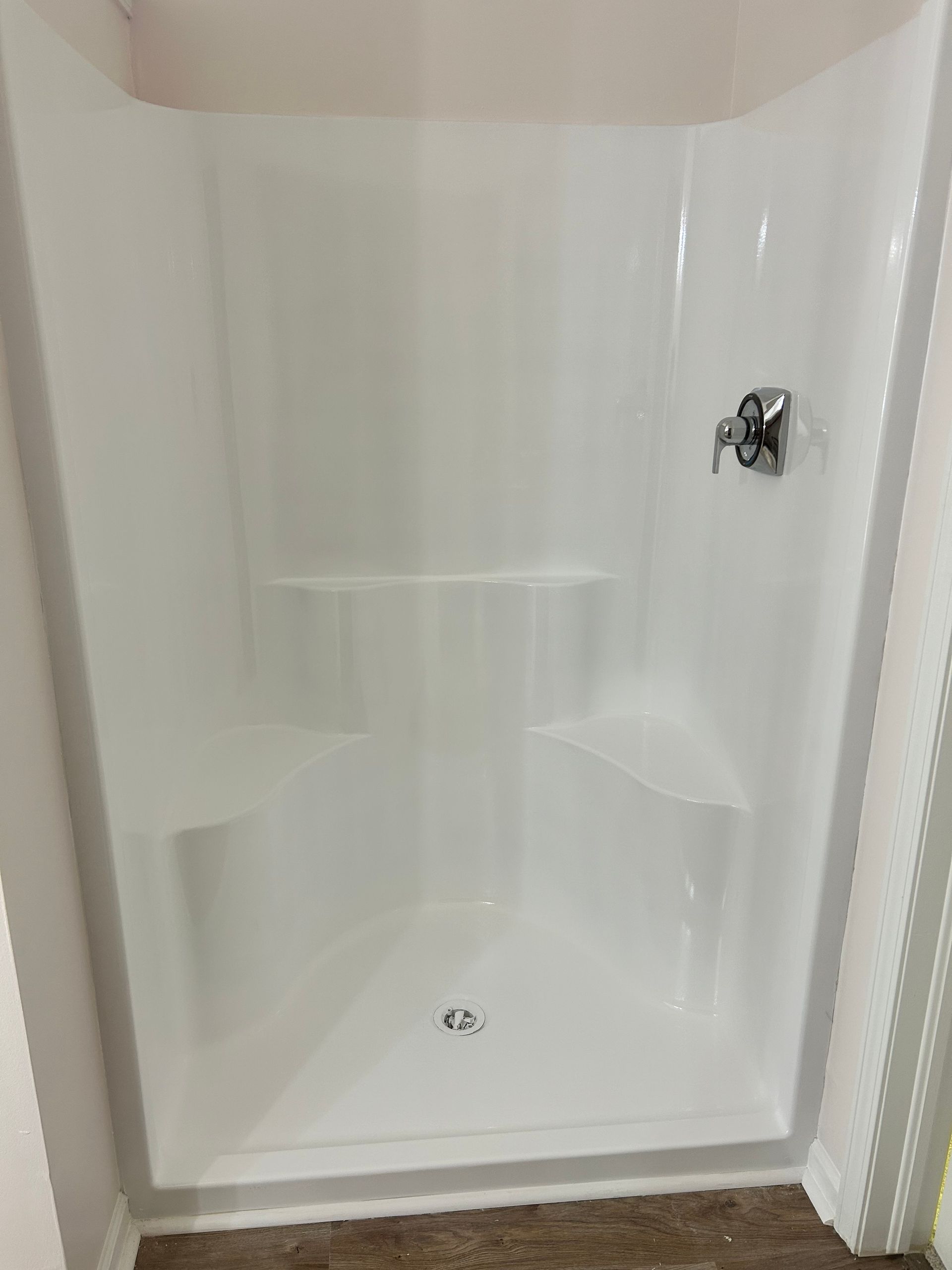 Here an image a transformed, clear, white and beautiful shower after a shower resurfacing job done by Ohio tub pros. 