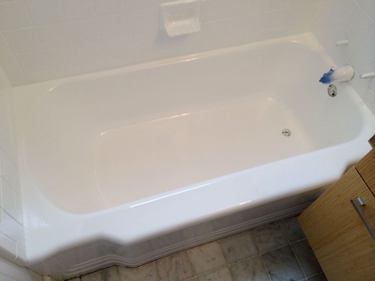 Picture of a bathtub with a glass sliding door. 