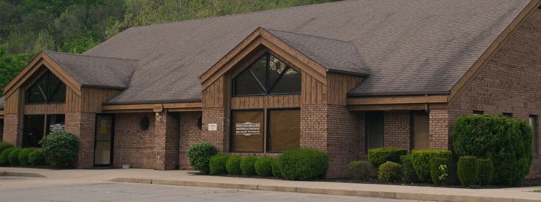 A row of brick buildings with a brown roof A row of brick buildings with a brown roof