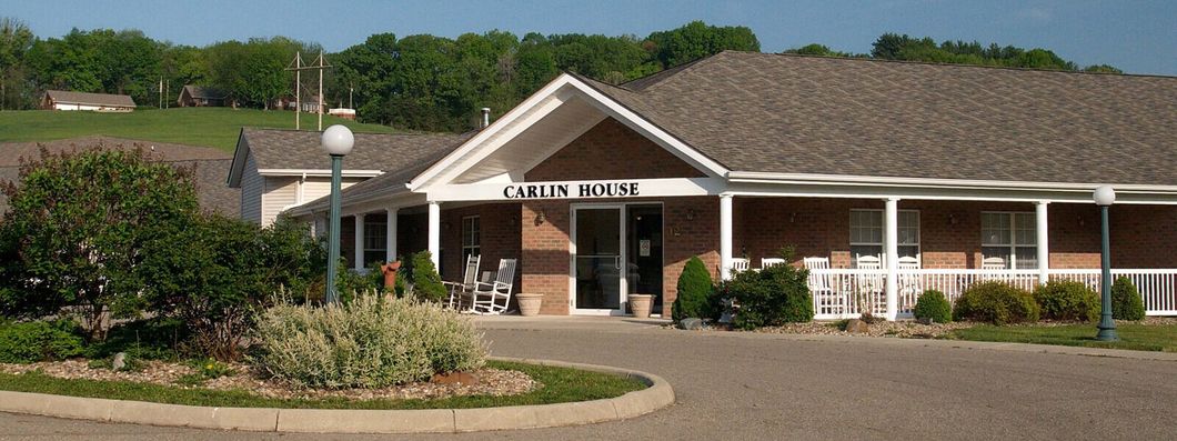 A brick building with a porch and a sign that says service center A brick building with a porch and a sign that says service center