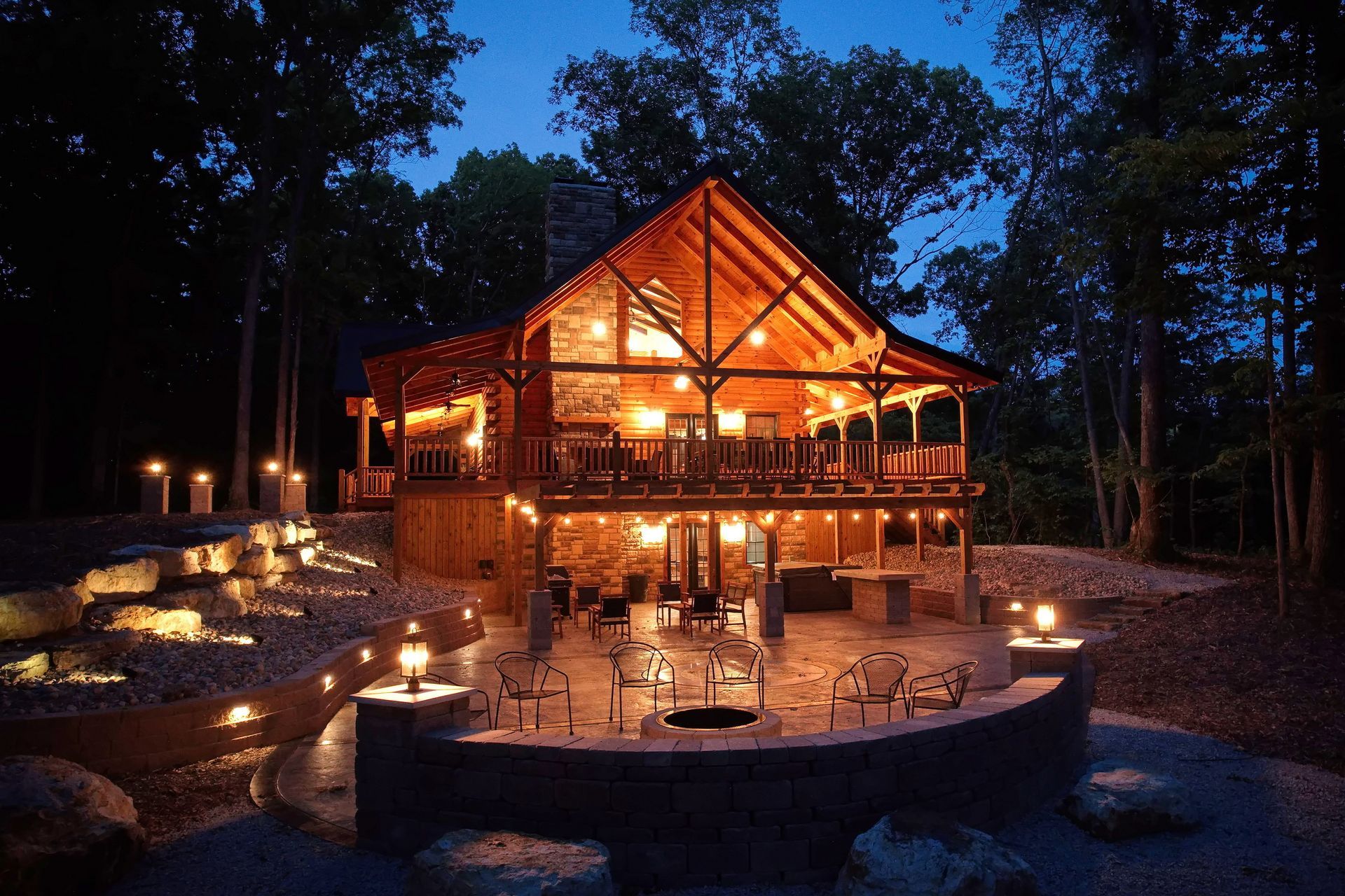 A large log cabin is lit up at night A large log cabin is lit up at night
