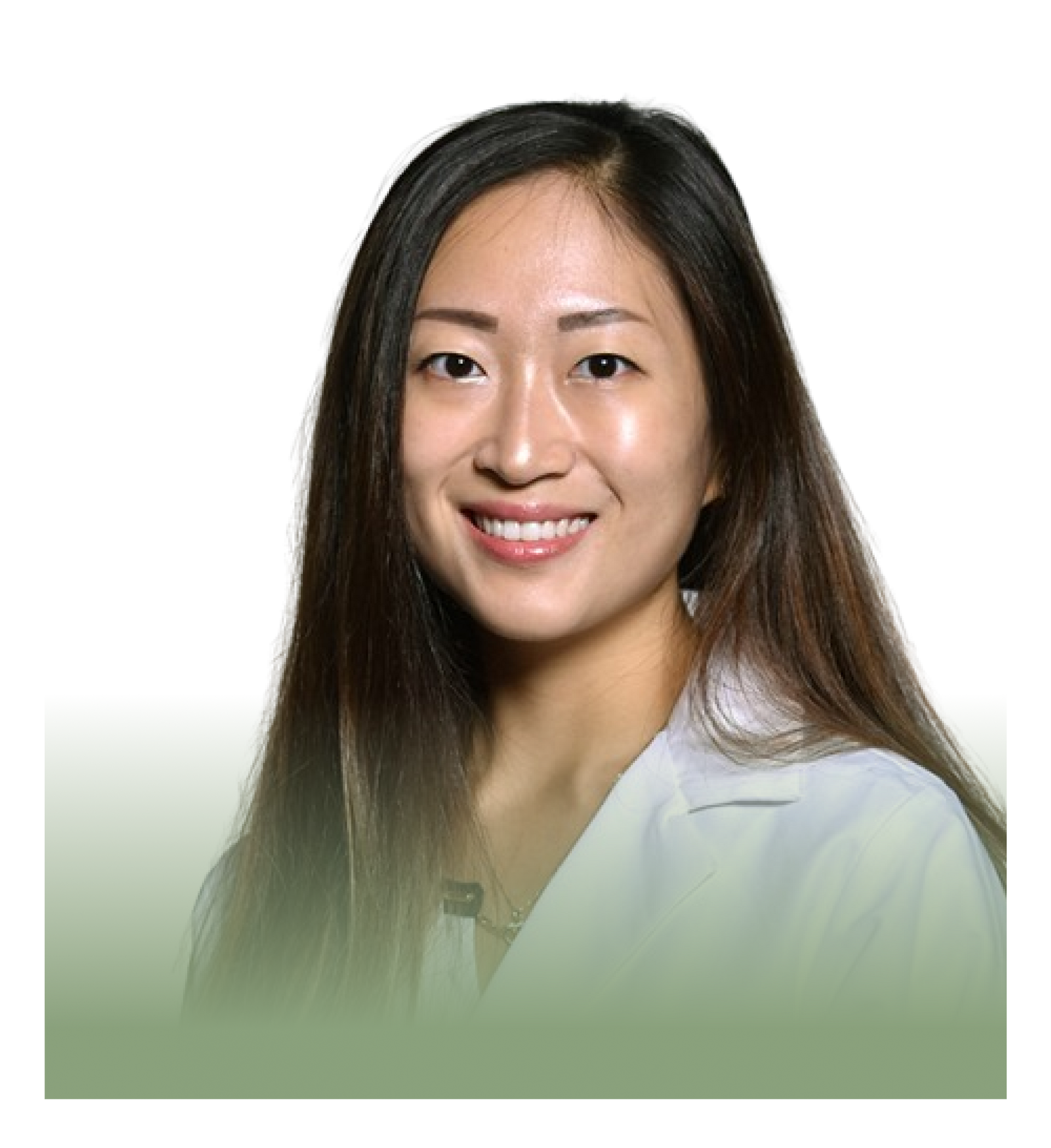 A woman in a white coat is smiling for the camera.