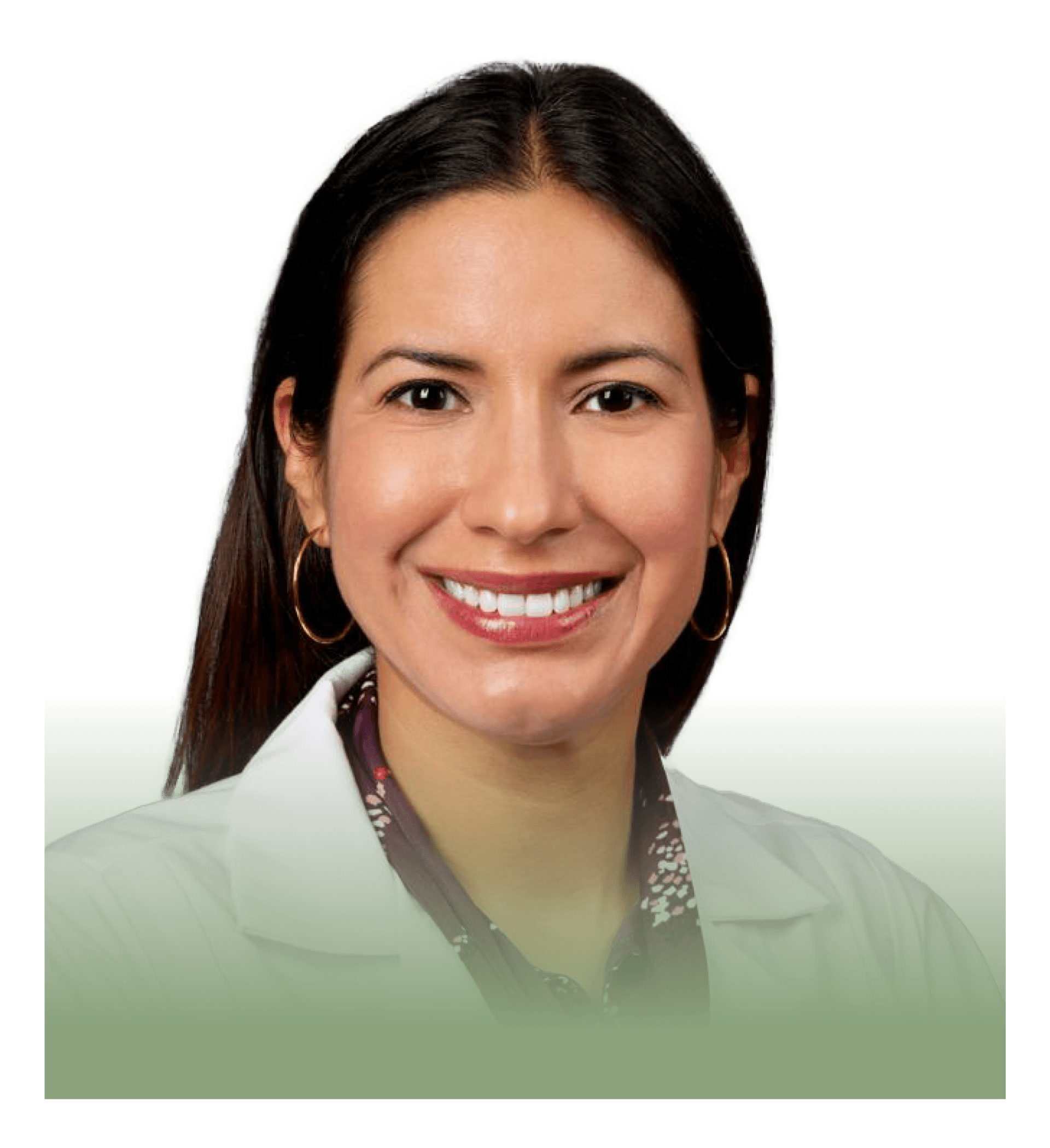 A woman in a white lab coat is smiling for the camera.