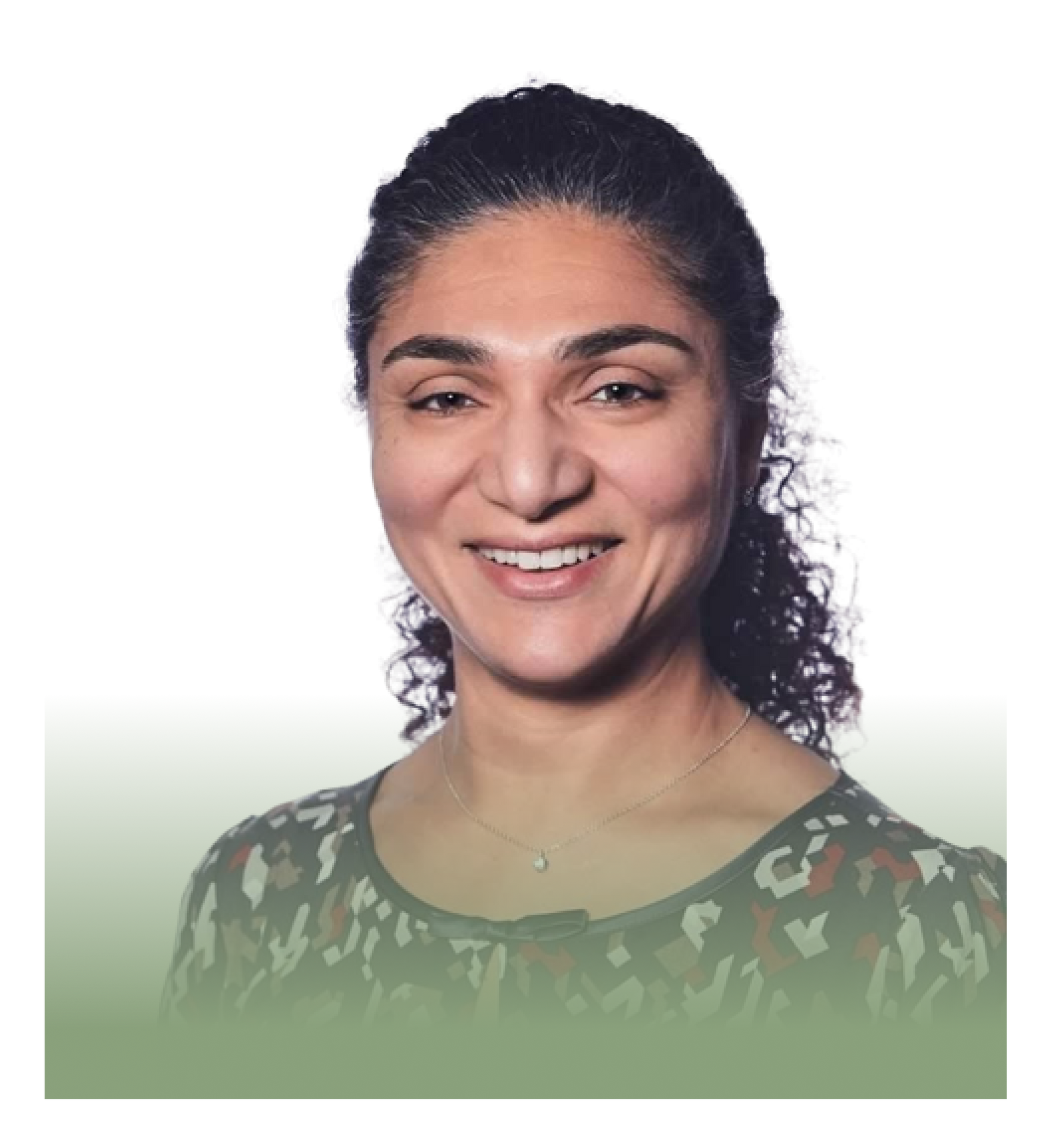 A woman with curly hair is smiling for the camera