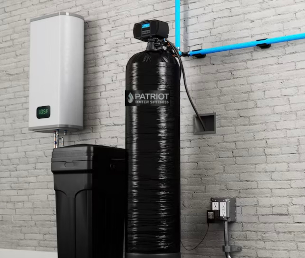 A water filtration system with a black tank and four filters mounted under a kitchen sink.