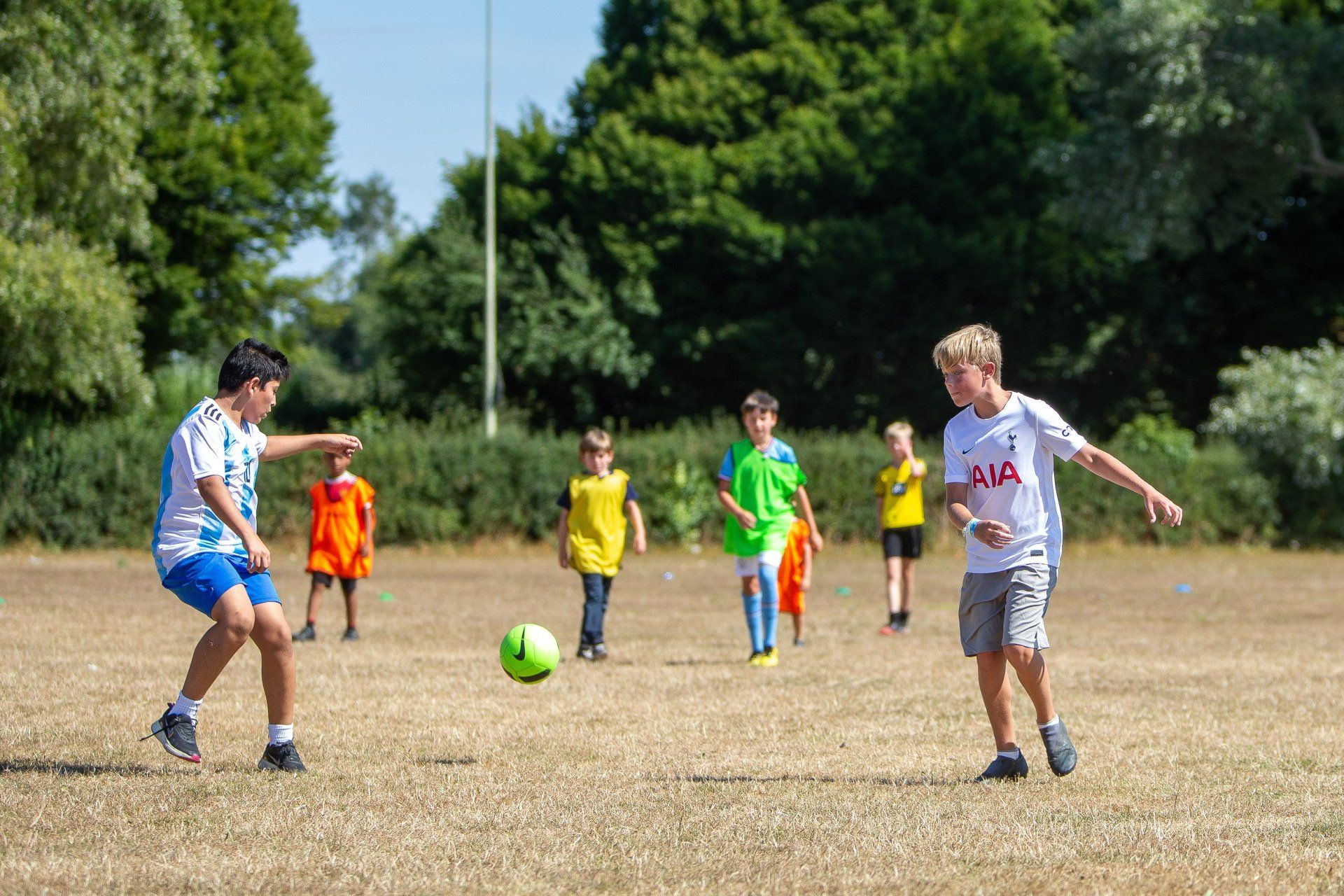 children playing soccer on the sports field;