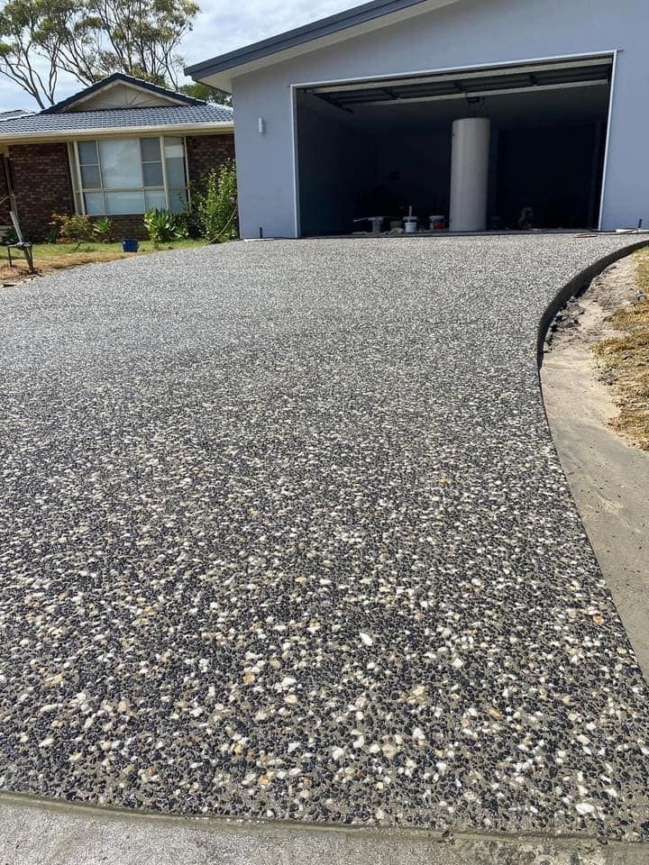 Gravel Driveway Leading to a Garage. the Driveway is Speckled Gray and White — JDC Concreting in Grafton, NSW