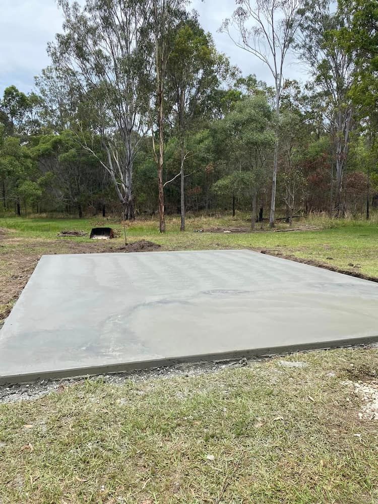 Newly Poured Concrete Slab in a Grassy Area, Surrounded by Trees — JDC Concreting in Ballina, NSW