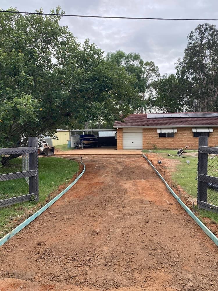 Driveway With Concrete Border, Awaiting Paving, Leading to a Garage and House — JDC Concreting in Grafton, NSW