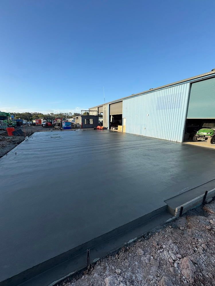 Freshly Poured Concrete Slab at a Construction Site, Next to a Building — JDC Concreting in Lismore, NSW