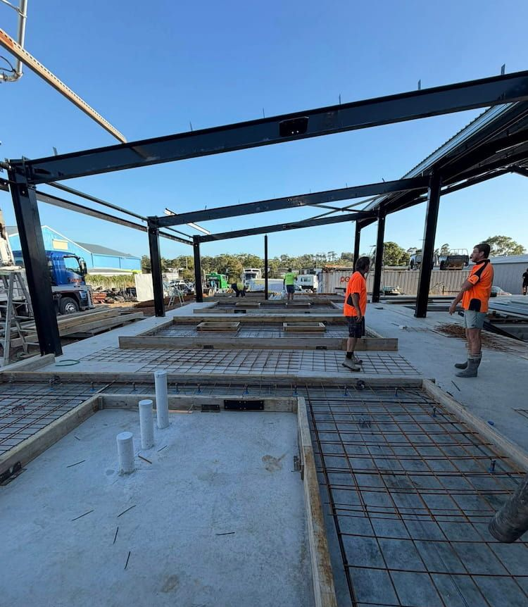 Construction Site With Workers, Steel Beams, Concrete Foundation, Rebar, and Blue Sky — JDC Concreting in Grafton, NSW