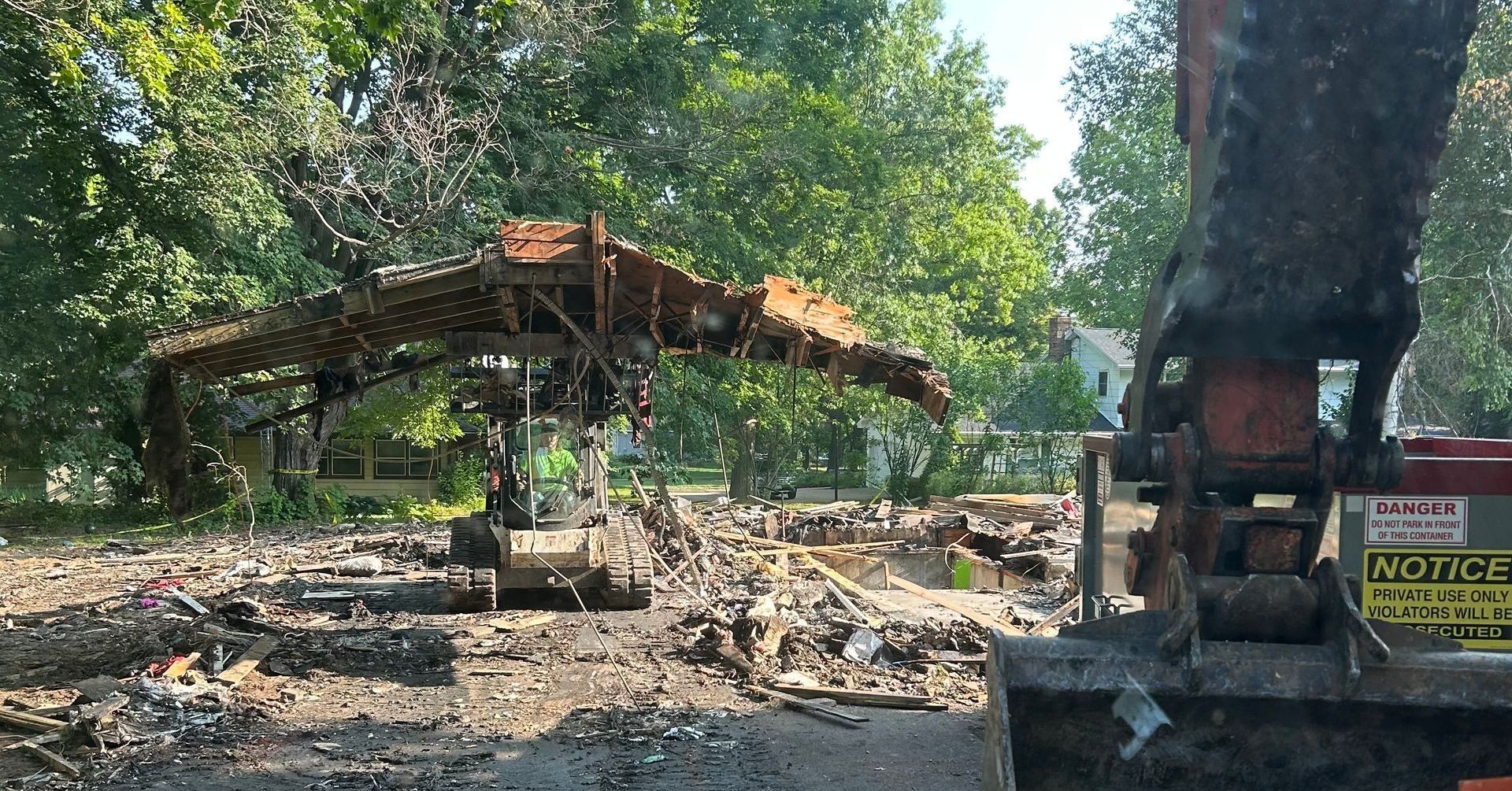 A large excavator is being used to demolish a building.