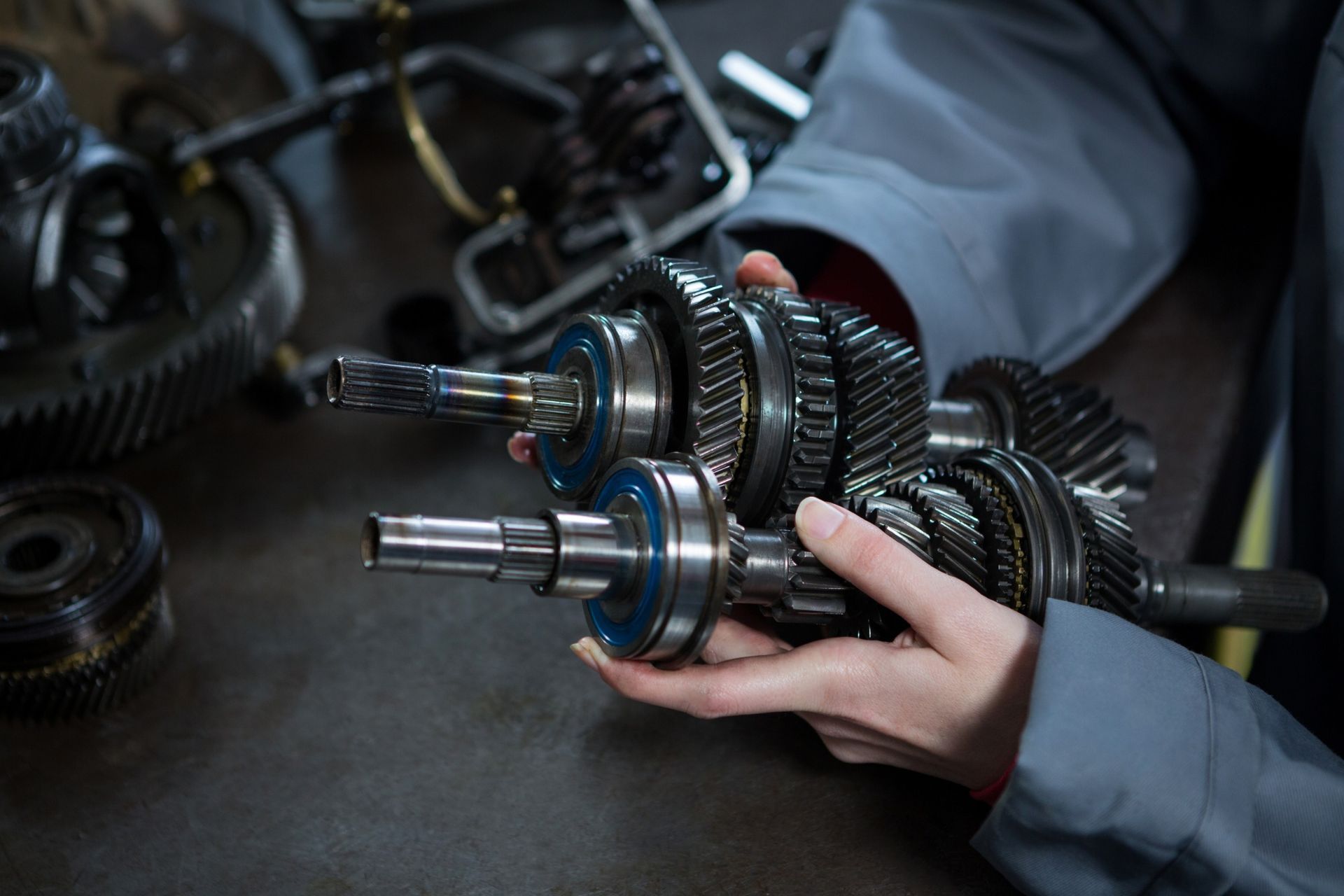 A person is holding a gearbox in their hands.