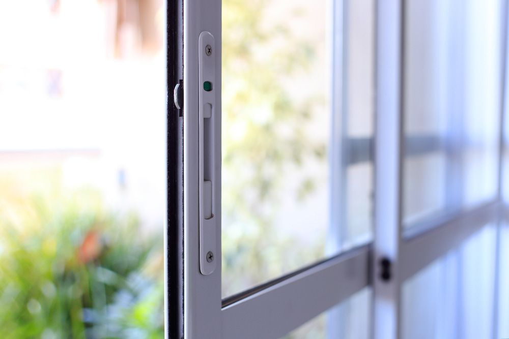A Close Up of a Sliding Glass Door With a Sliding Screen Door — Twin Cities Glass In Albury, NSW
